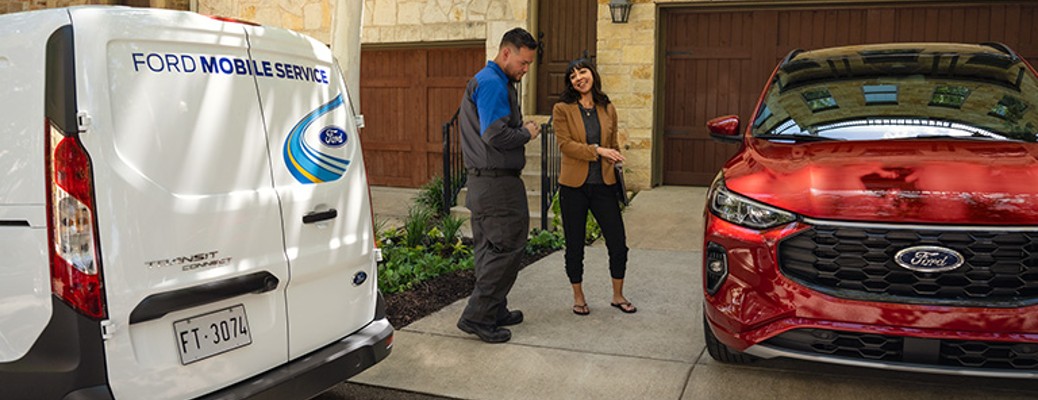 2023 Ford mobile service van with two people and a red vehicle
