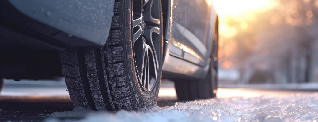 Closeup of a winter tire being driven in snow
