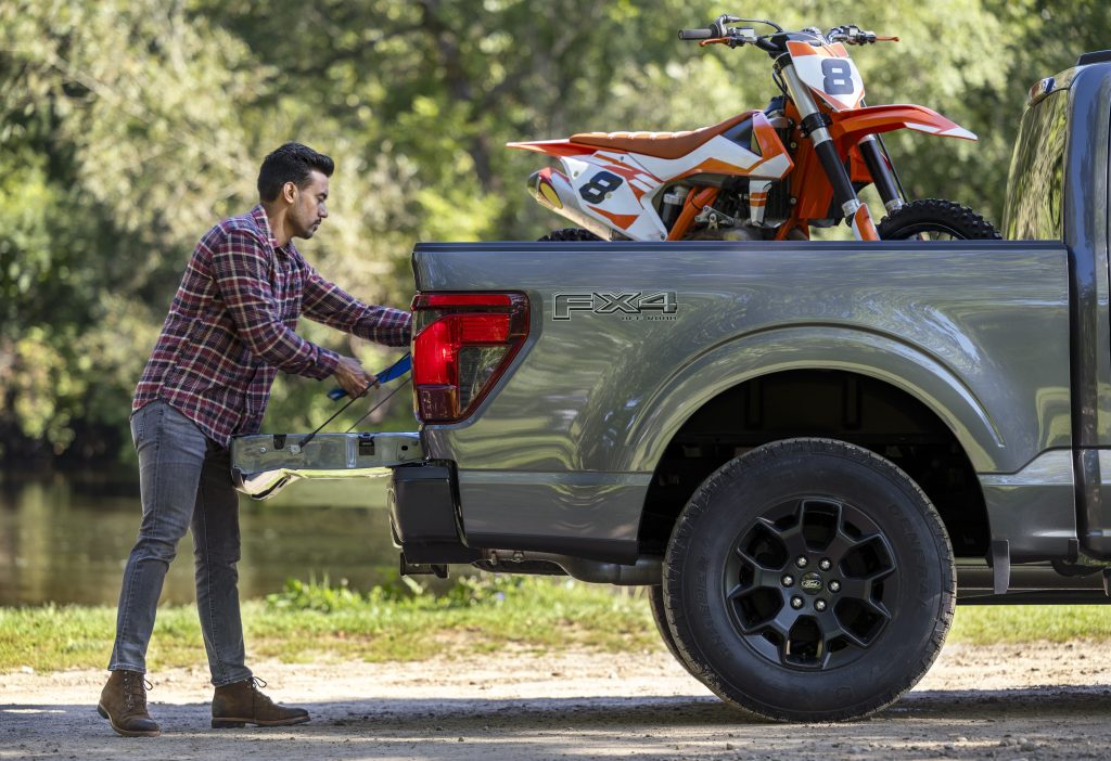 2024 Ford F-150 STX rear end with a man