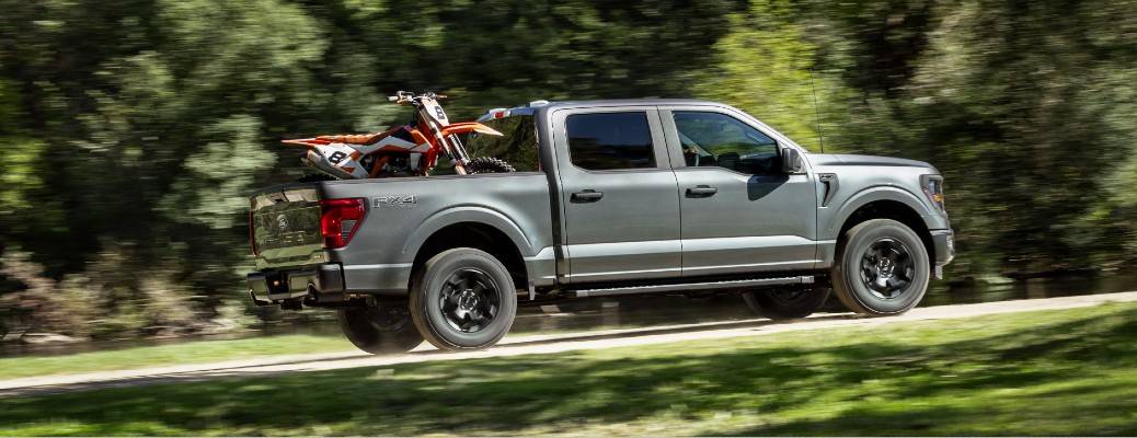 2024 Ford F-150 STX side view hauling a bike