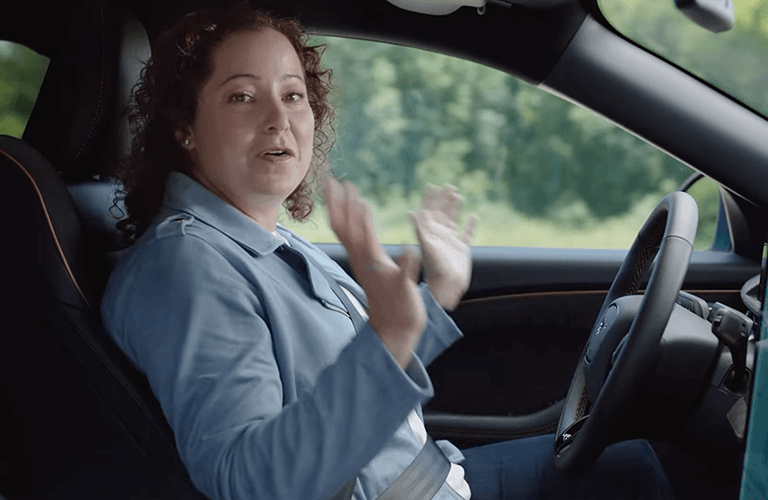 a woman driving a vehicle hands-free