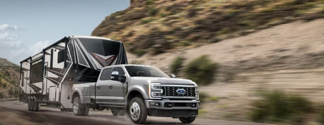 A 2024 Ford Super Duty truck towing a trailer on a road