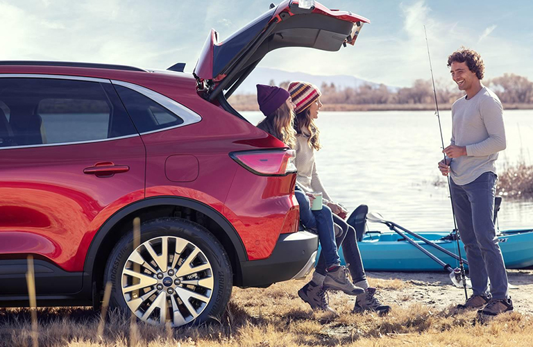 2020 Ford Escape with rear trunk open and three people