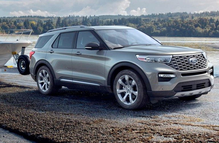 2020 Ford Explorer side view on a road towing a boat