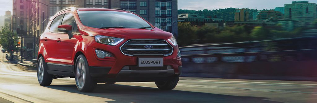 red 2020 Ford EcoSport driving in a city