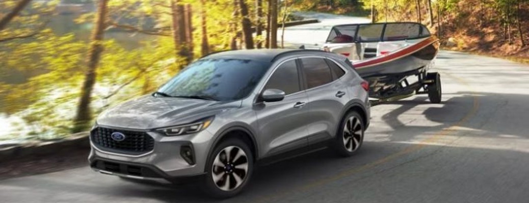 2024 Ford Escape towing a boat in a forest