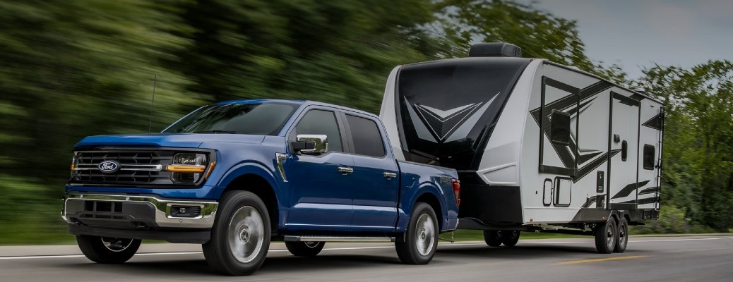 2025 Ford F-150 front and side view towing a trailer