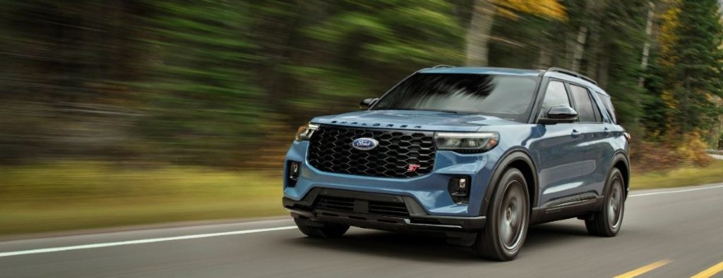 2025 Ford Explorer ST front and side view in blue on a road