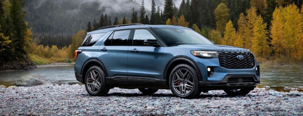 2025 Ford Explorer ST side view in blue on rocks