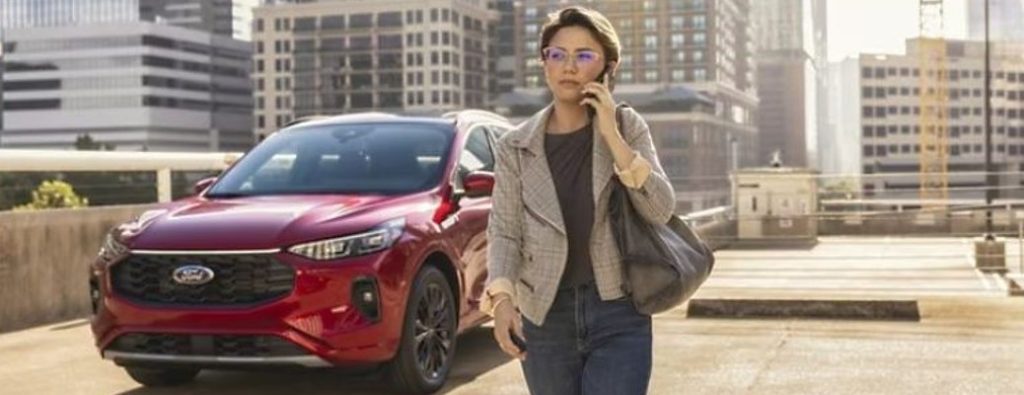 2025 Ford Escape front view in a city with a woman