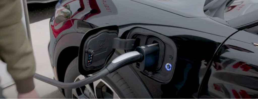 A charger plugged into a 2025 Ford Mustang Mach-E electric vehicle