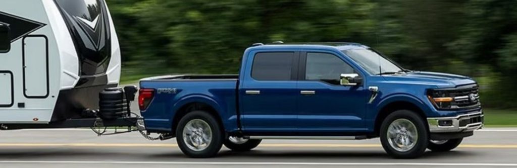 2025 Ford F-150 XL side view towing a trailer
