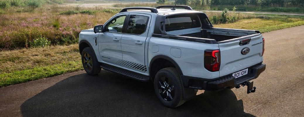 2025 Ford Ranger PHEV rear view by a field