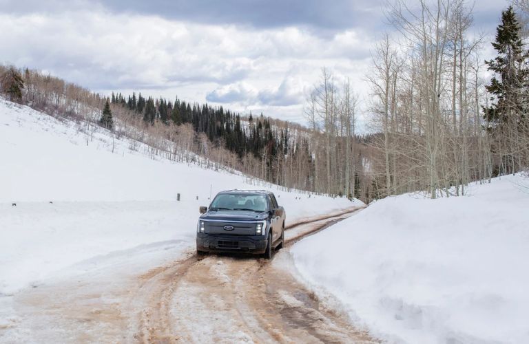 A Ford truck driving on a snowy road