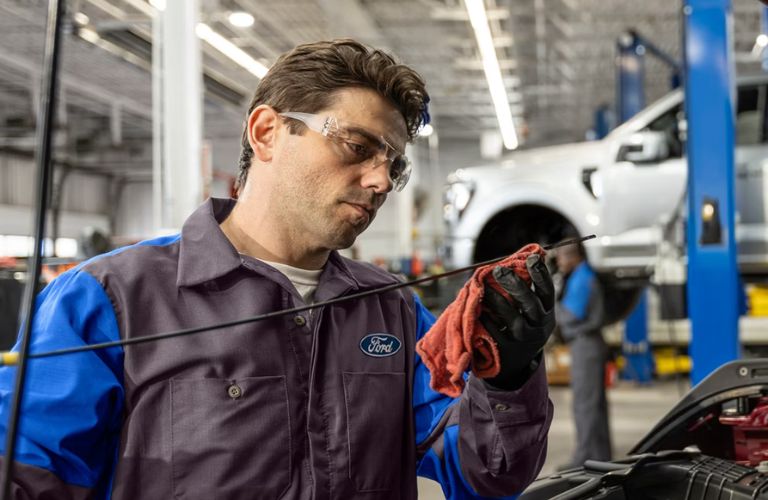 a Ford service technician working on a car