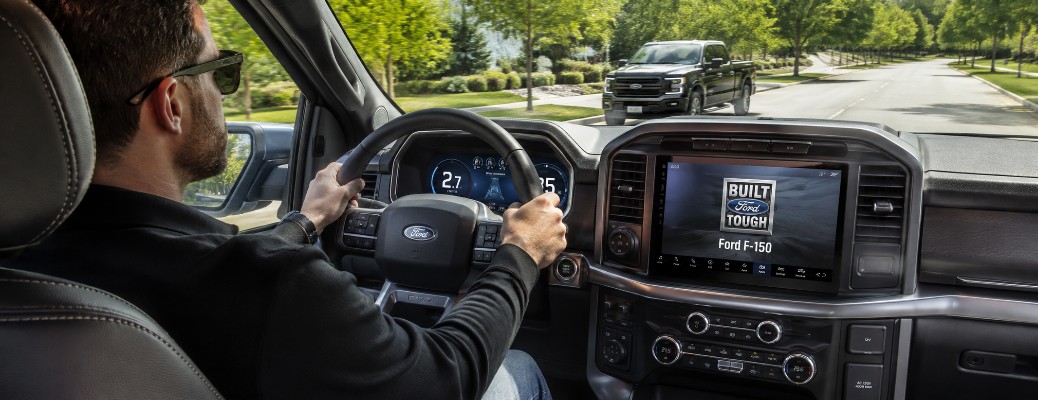Driver behind the wheel of Ford F-150 for a test drive