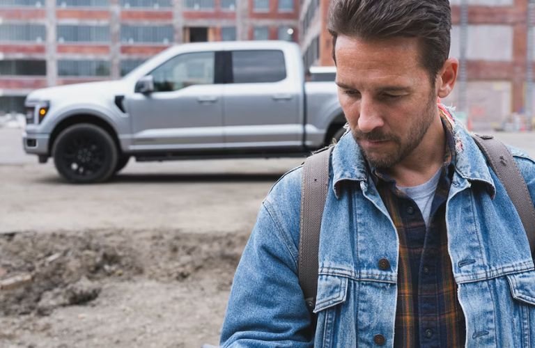 a man on a work site with his truck in the background