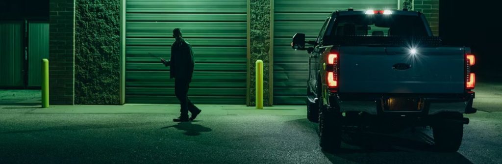 a person by a vehicle at night
