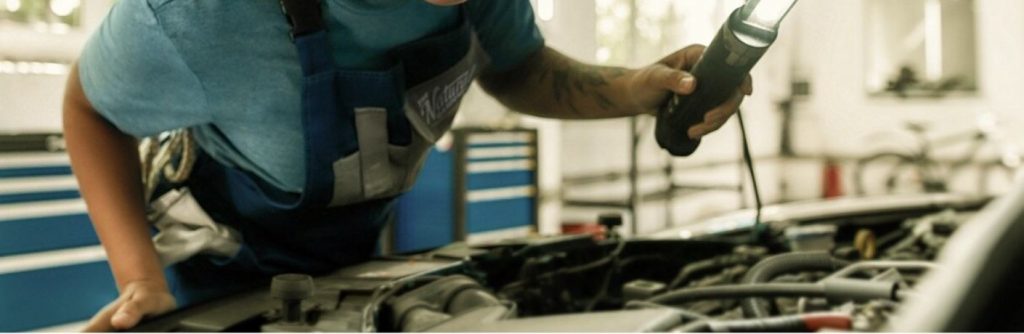 a person leaning over an engine