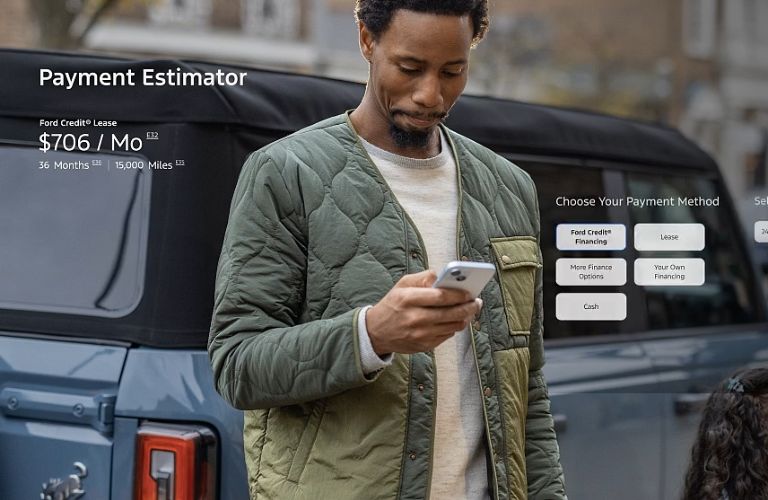 a person looking at a payment estimator for a Ford