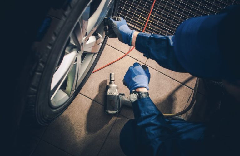 Hands of a man working on a tire
