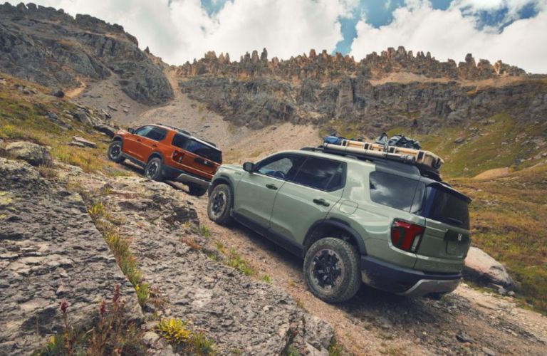 side view of two 2026 Honda Passport off-roading