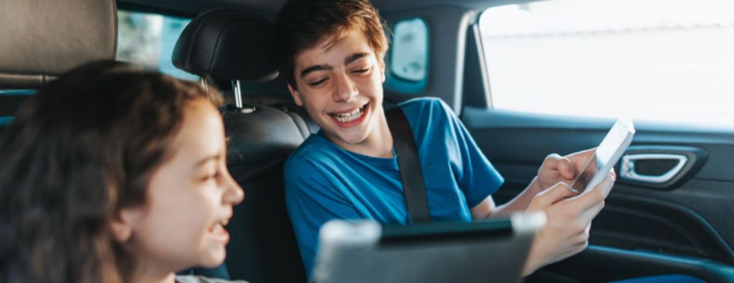 a young boy and girl in a car