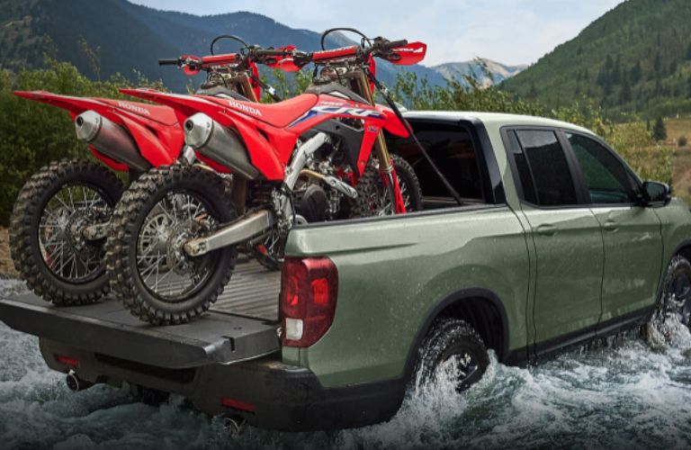 side view of a Honda carrying two motorbikes