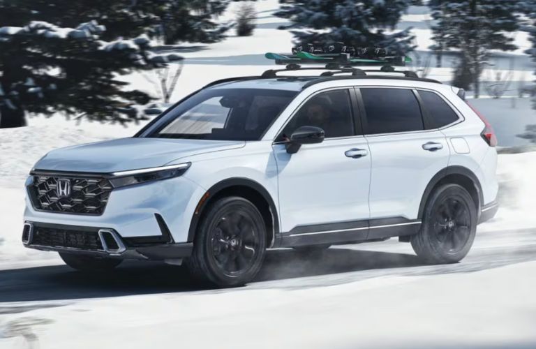 side view of a Honda on a snowy road