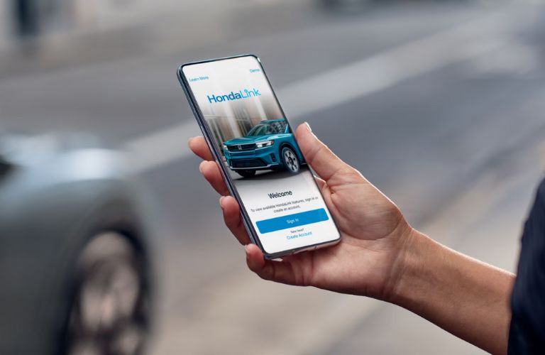 a person accessing HondaLink in their phone