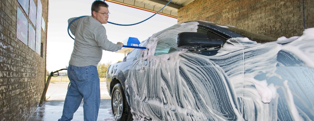 a man washing a car