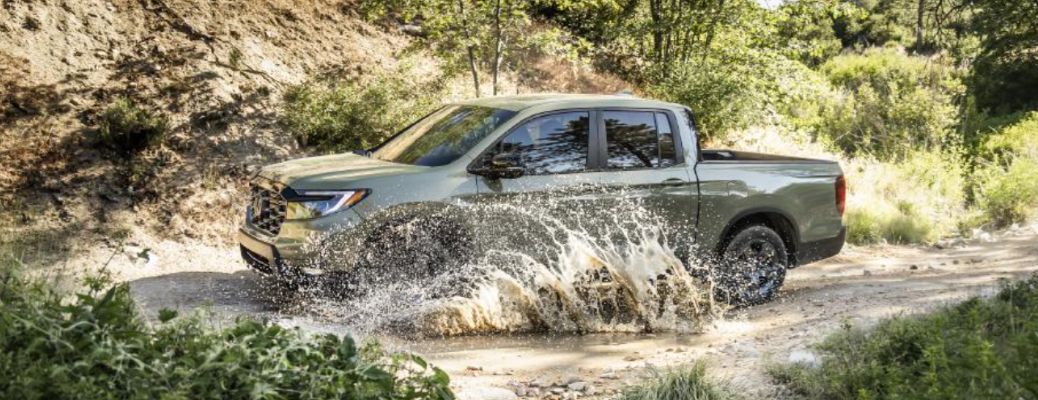 side view of the 2026 Honda Ridgeline off-roading in water