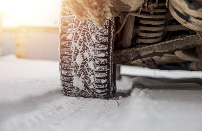close up of a tire in snow