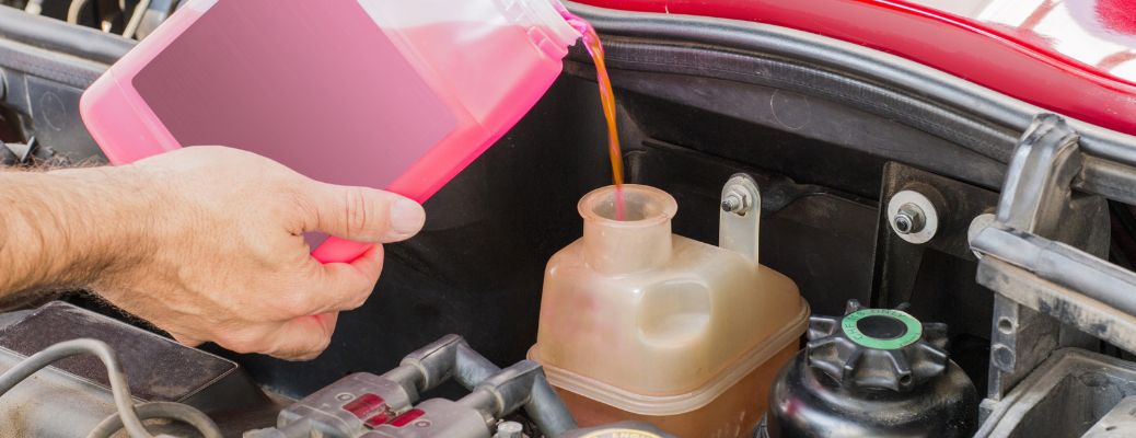 close up of fresh coolant being poured in a car