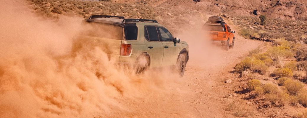 Two 2026 Honda Passport SUVs in desert road