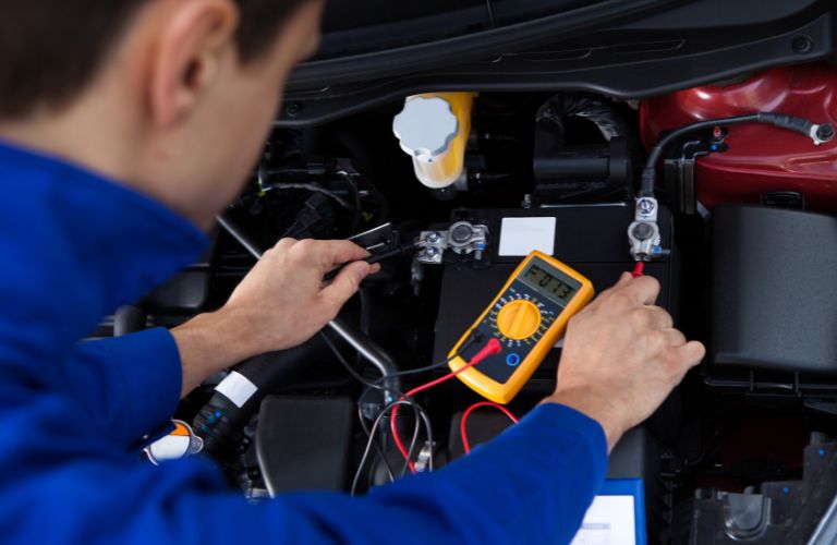 Mechanic testing the car battery