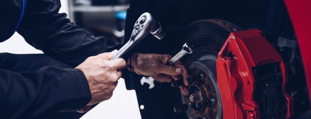 Hands of a man working on a vehicle