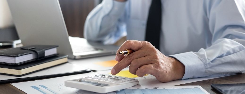 Hand of a man using a calculator