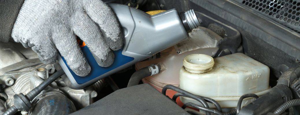 Mechanic topping up brake fluid