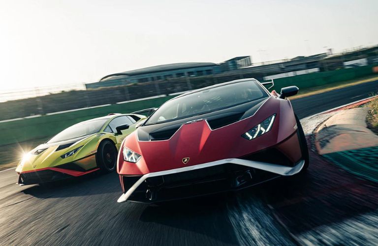 Two Lamborghini Huracan STO cars on a race track