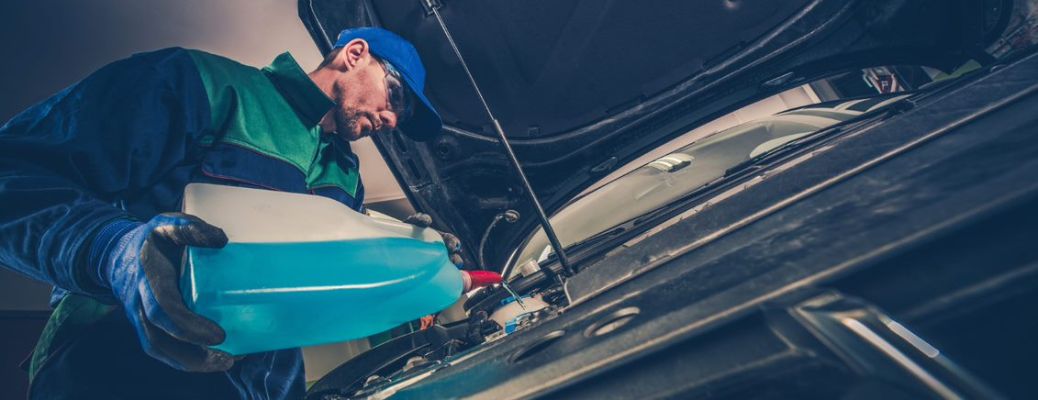 Mechanic pouring fluid