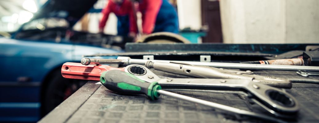tools in the foreground and technicians working in the background