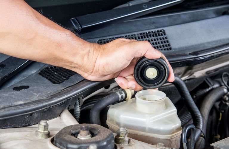 brake fluid being poured into the vehicle