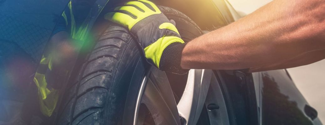 representative image of a technician rotating a tire