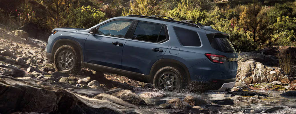 A side exterior view of the 2026 Honda Pilot Trailsport off-roading