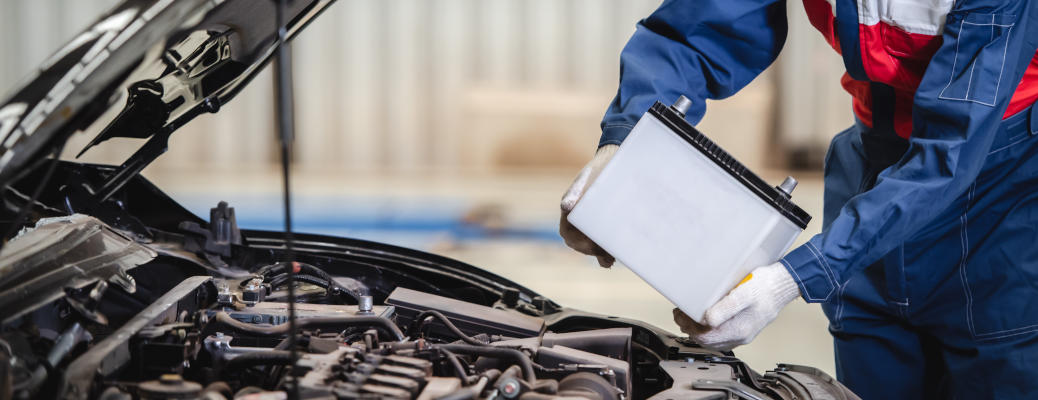 A mechanic replacing a car's battery