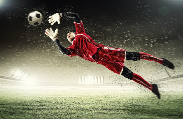 Soccer player stopping the ball