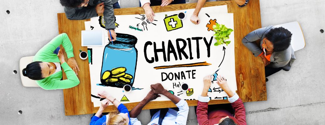 People sitting around table with charity-donate chart
