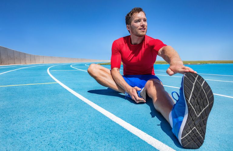 Man stretching on a track