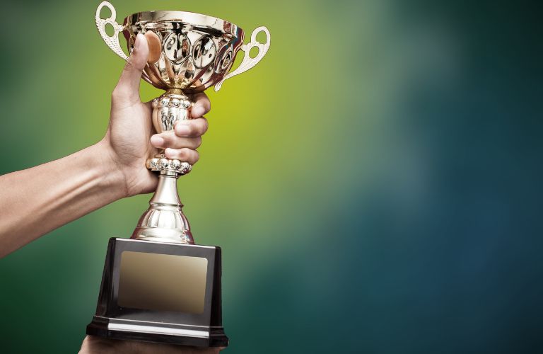 Hand holding a trophy
